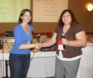 Liz Anderson receives the first place plaque from GM Marcy Morelli