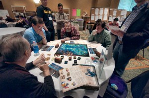 Victor Hutcherson (foreground) leads a teaching demo of one of the new additions to the Wild Card lineup this year -- Merchants and Marauders.